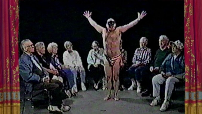 A half-naked masked man dances for old people