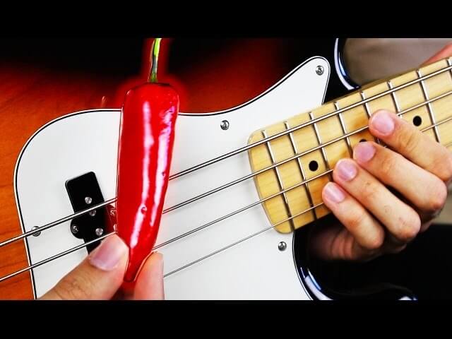 Guy plays Red Hot Chili Peppers using a red hot chili pepper