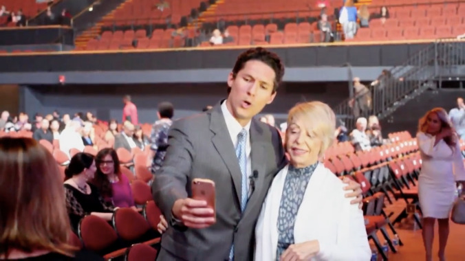 Watch a guy who looks a lot like Joel Osteen crash a Joel Osteen event, evade authorities