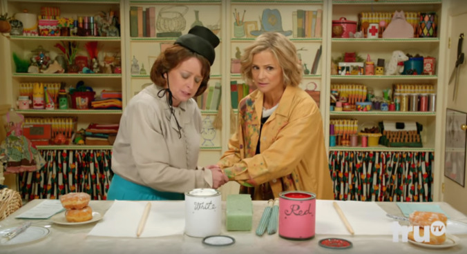 Amy and Rachel Dratch say a prayer before crafting in an At Home With Amy Sedaris exclusive