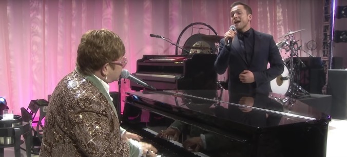 Come watch Elton John perform "Tiny Dancer" alongside his shadow self, Rocketman's Taron Egerton