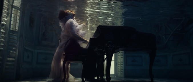 Harry Styles literally drowns his sorrows in a somber music video for "Falling"