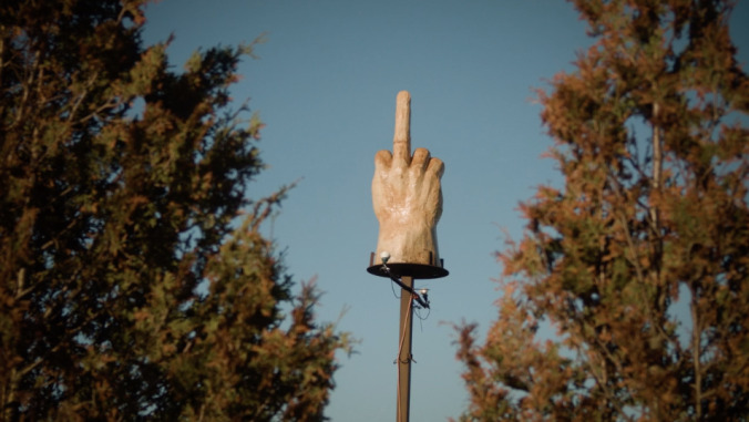 Watch a short documentary about the guy who built a giant wooden middle finger in his yard