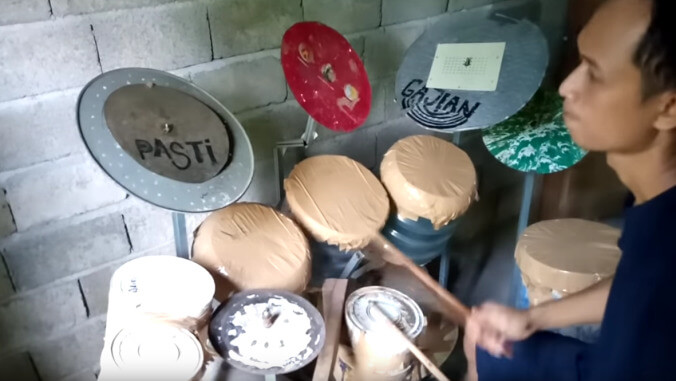 Guy builds homemade drum kit, plays along to "Tom Sawyer" on it