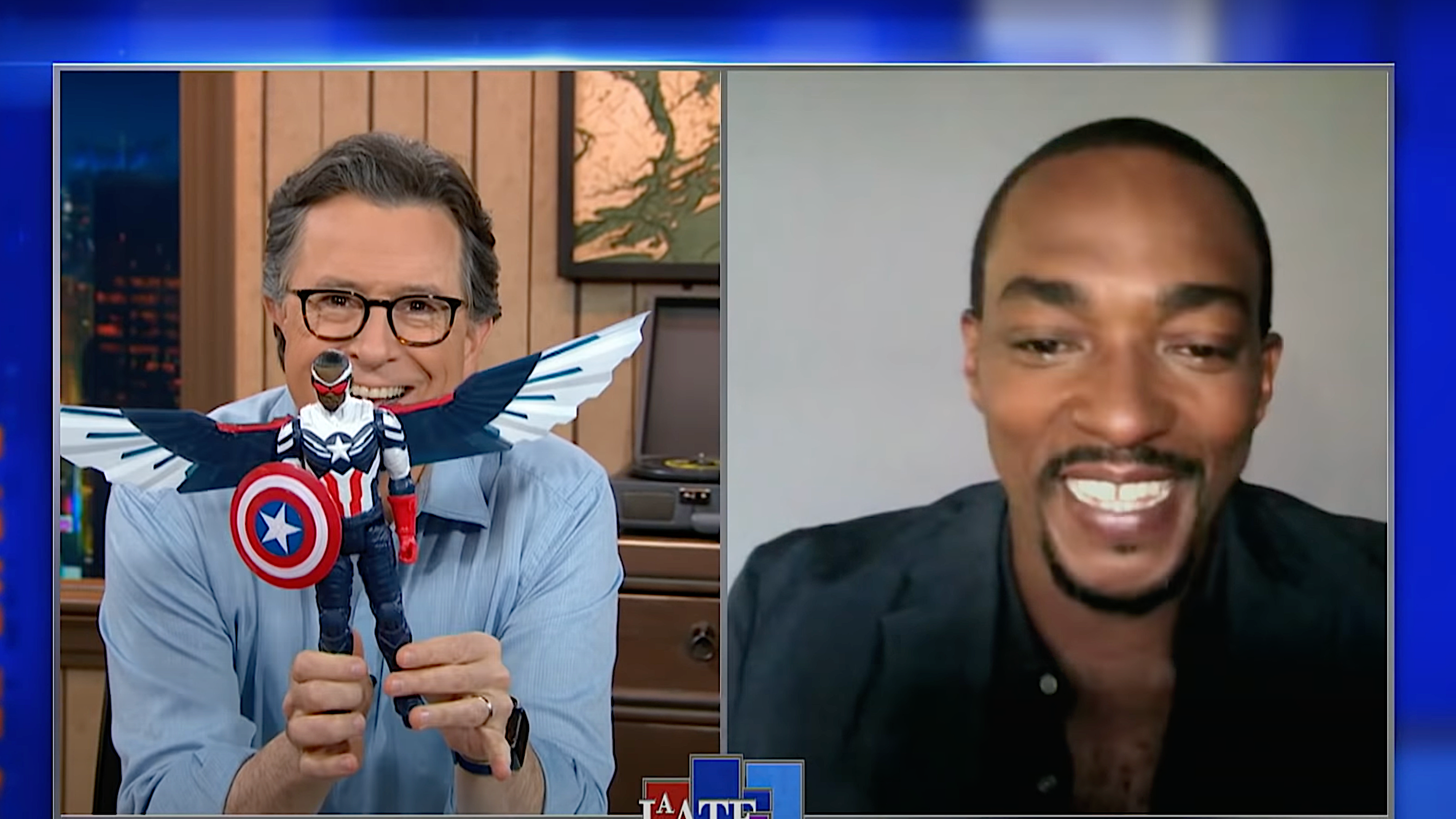 Stephen Colbert shows off his pre-release Captain America doll to an envious Anthony Mackie