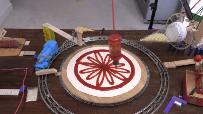 Today in needlessly complicated culinary robots: A toy train makes a pizza