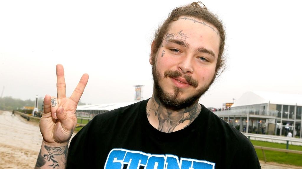 Refusing to be outdone by Lil Uzi Vert's forehead diamond, Post Malone gets some diamond fangs