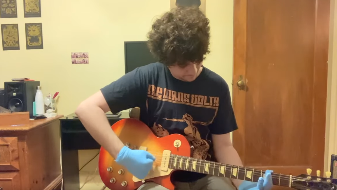 Guitarist conducts study to find out how many gloves he can wear while playing “Enter Sandman”