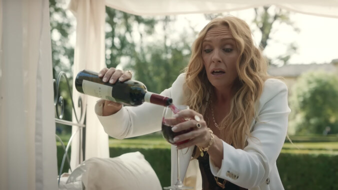 Toni Collette leads the mob with a gun and a glass of wine in hand in Mafia Mamma trailer