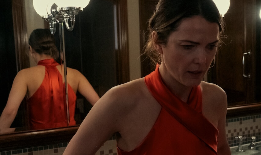 keri russell in the diplomat looking concerned in red dress in bathroom - keri russell in the diplomat season 2 first look