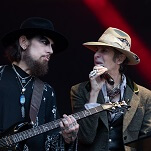 Perry Farrell literally dragged off stage after taking swing at Dave Navarro mid-song