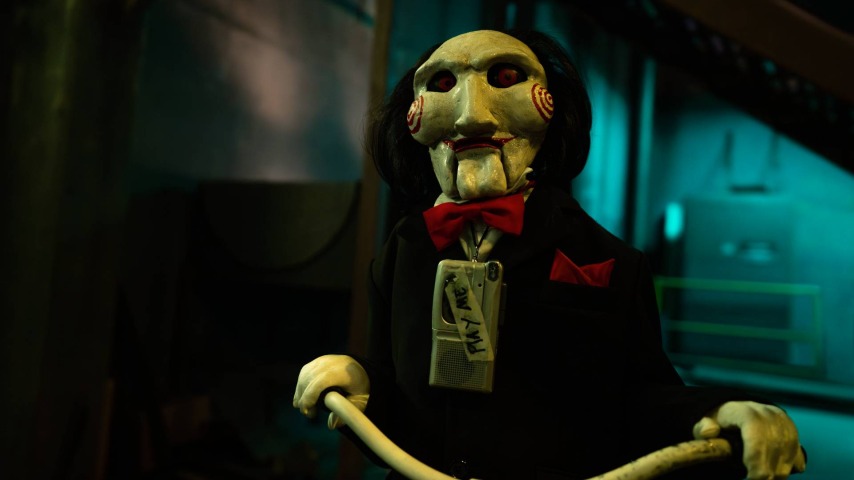 Billy the Puppet riding his tricycle in Saw X