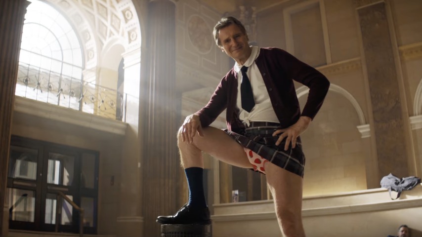 liam neeson in a school girl's uniform in the naked gun teaser