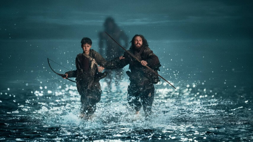 Jamie (Aaron Taylor-Johnson) and his son Spike (Alfie Williams) being chased by a Berserker in Columbia Pictures' 28 YEARS LATER.