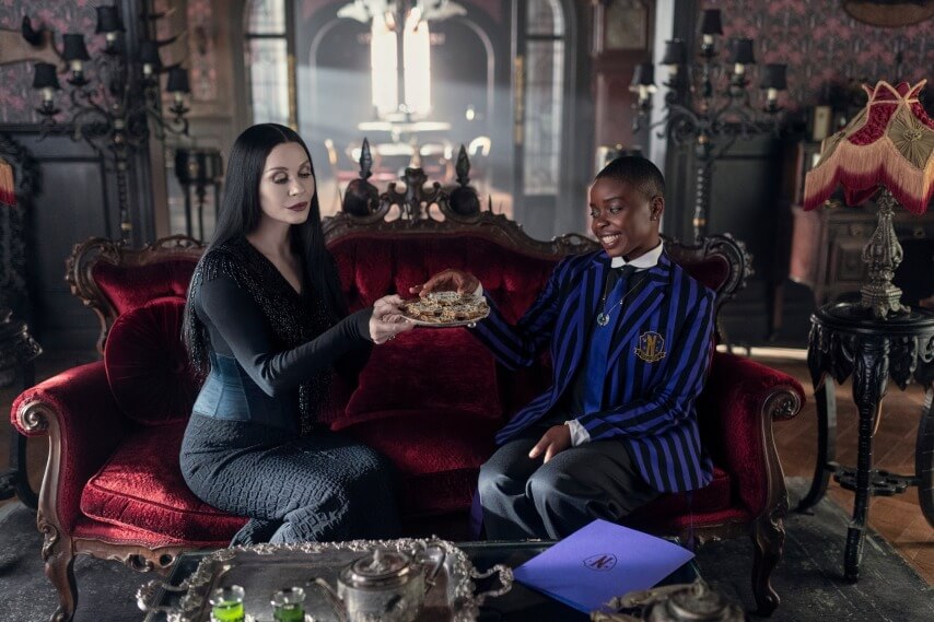 (L to R) Catherine Zeta-Jones as Morticia Addams, Joy Sunday as Bianca Barclay in episode 202 of Wednesday. Cr. Jonathan Hession/Netflix