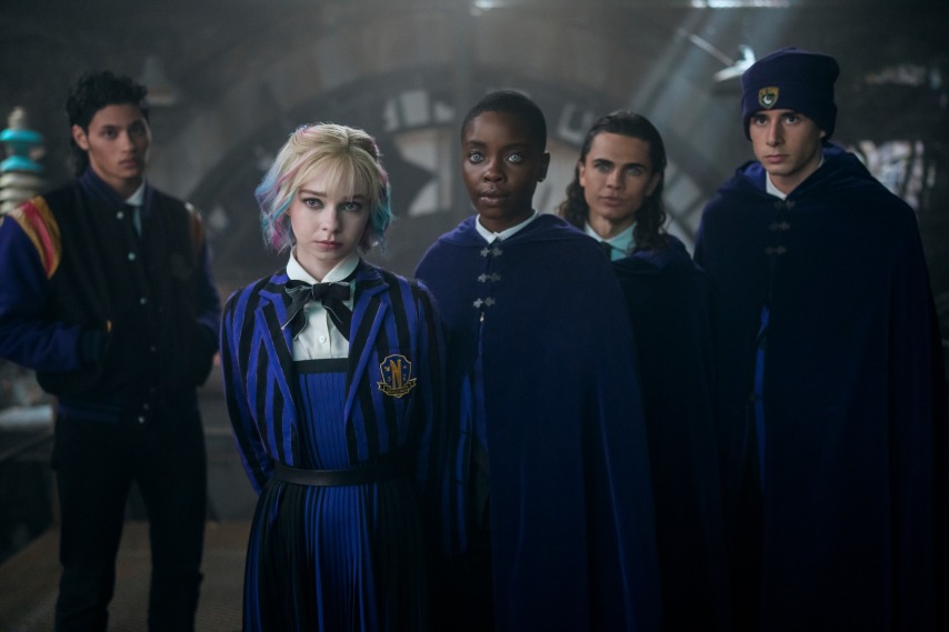 Wednesday. (L to R) Noah B. Taylor as Bruno, Emma Myers as Enid, Joy Sunday as Bianca, Oliver Watson as Kent, Georgie Farmer as Ajax in episode 205 of Wednesday. Cr. Bernard Walsh/Netflix © 2025