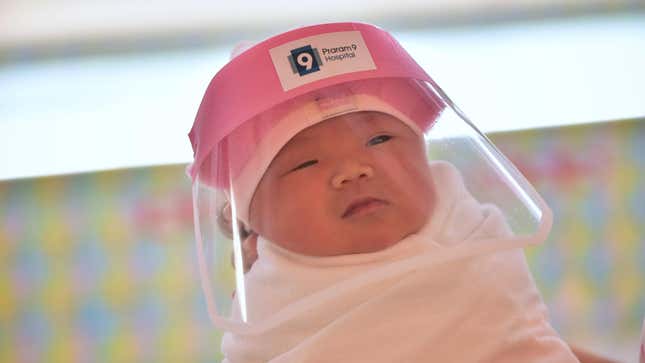 Here's a Slightly Crotchety Baby In the Tiniest PPE You've Ever Seen