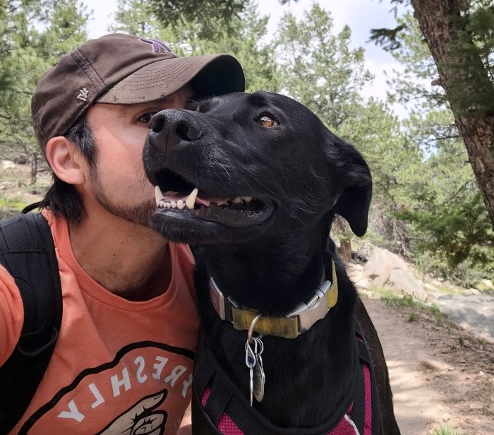 Me kissing Rocky in the woods as he has a smile on his face that I will remember forever