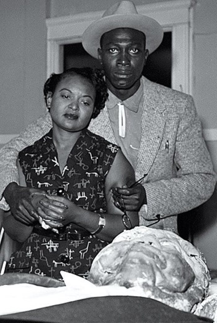 Mamie Till, her fiancé Gene Mobley, looks over 14-year-old son Emmett Till's mutilated corpse after being abducted and lynched in Mississippi in 1955 (Wikimedia Commons)