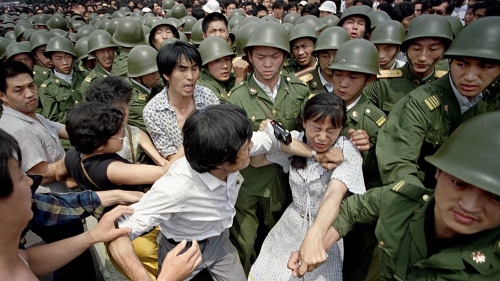 1989 Tiananmen Square democracy protests, the People's Liberation Army tried to pull this female student out of the protest rally (Voice of America/Wikimedia Commons)