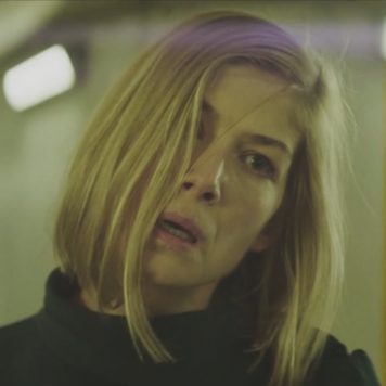 Watch Rosamund Pike Thrash About In Massive Attack and Young Fathers' New Video